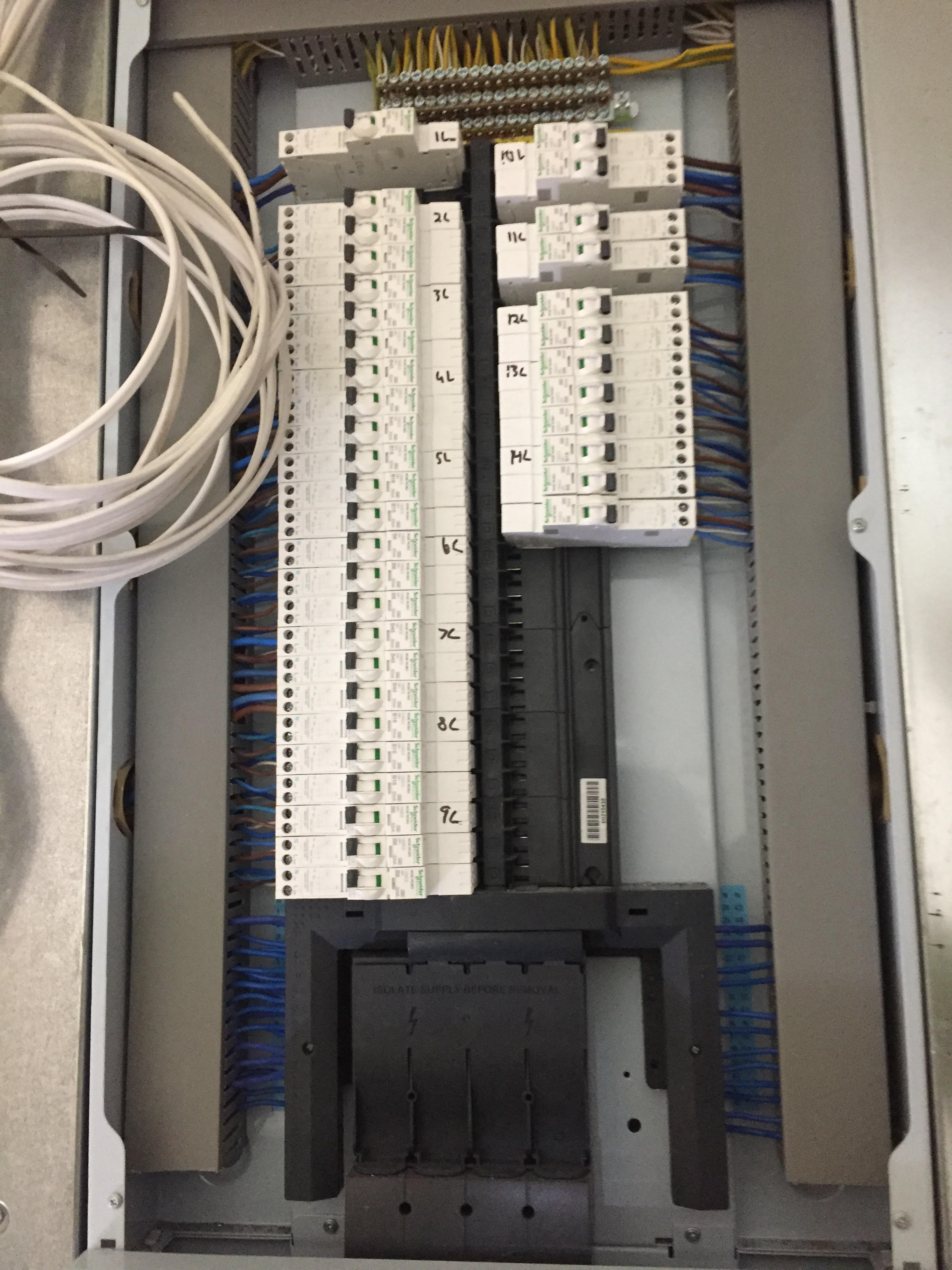 Open electrical distribution board with labelled breakers